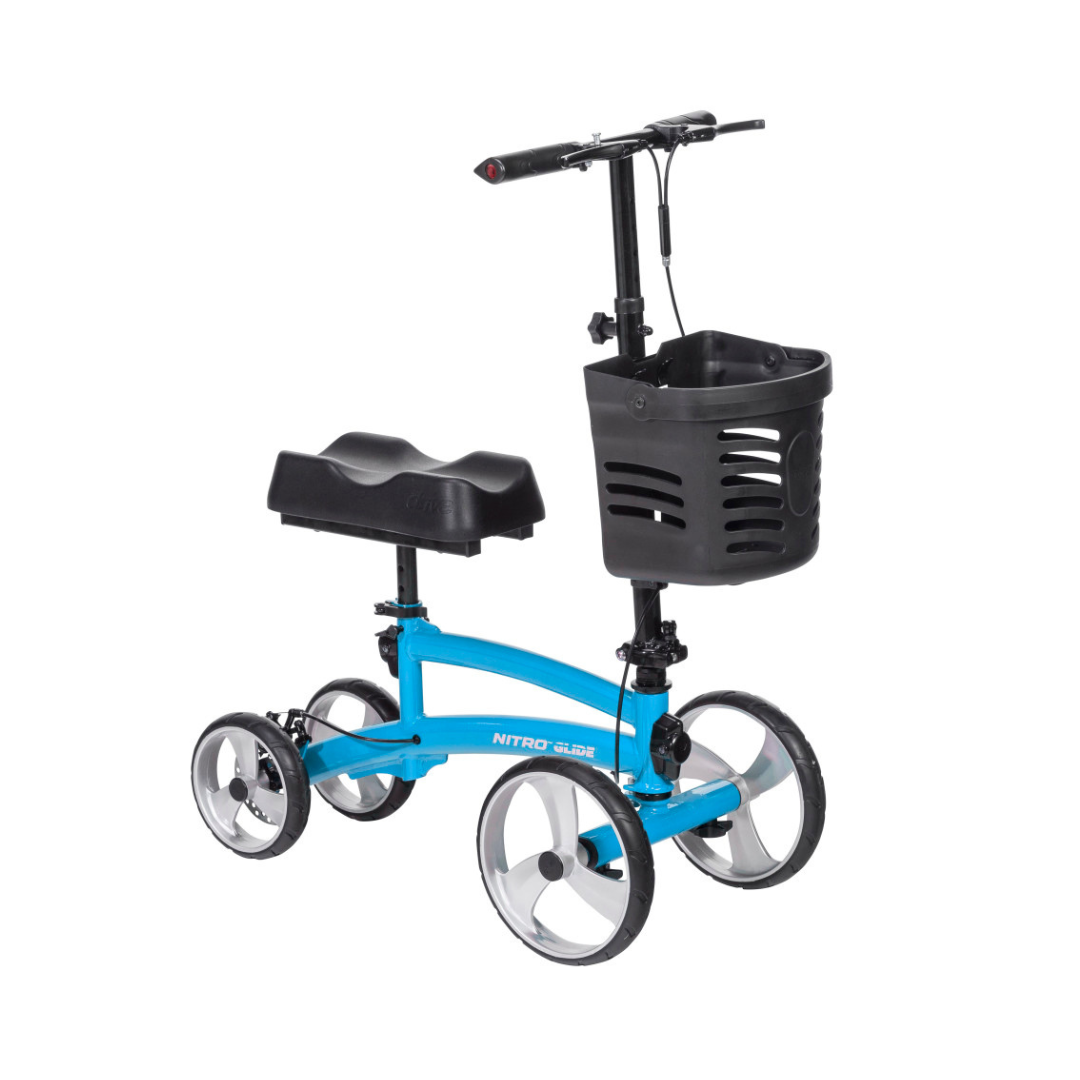 The Drive Folding Nitro® Glide Knee Walker features four large wheels, a black padded knee rest, a sturdy handlebar, and a front black plastic basket—an ideal crutch alternative for comfortable foot injury recovery.